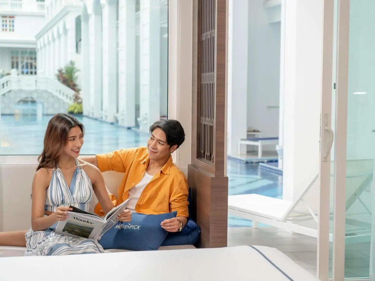 Indoor Pool Area with Modern Seating and Stone Staircase Near Patong Beach