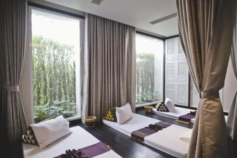 Indoor Relaxation Room with Floor Beds and Large Windows in Phra Nakhon
