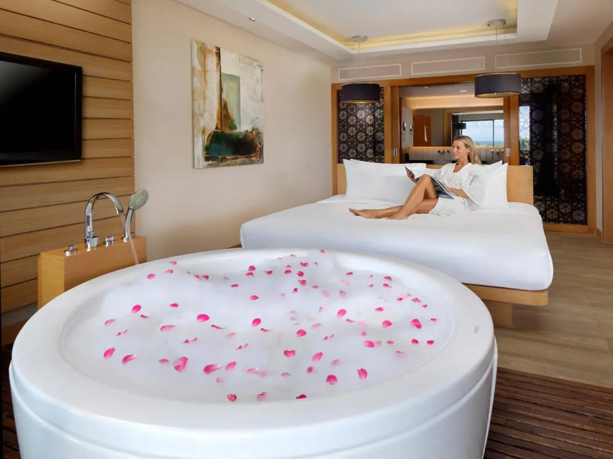 Indoor Room Featuring Circular Bathtub with Rose Petals and Relaxing Bed at Kata Beach