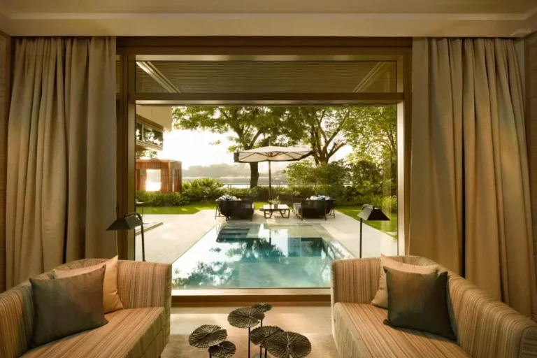 Indoor Seating Area Overlooking Outdoor Pool and Garden in Sathorn with Lake View
