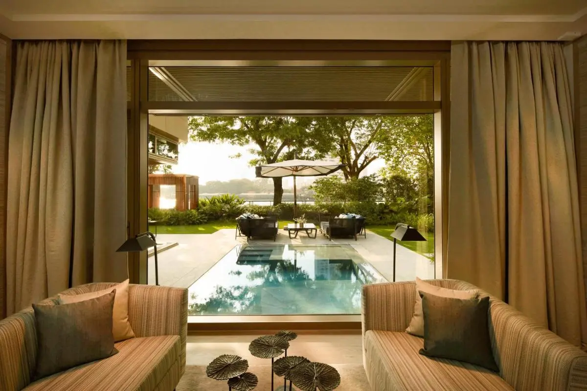 Indoor Seating Area Overlooking Outdoor Pool and Garden in Sathorn with Lake View