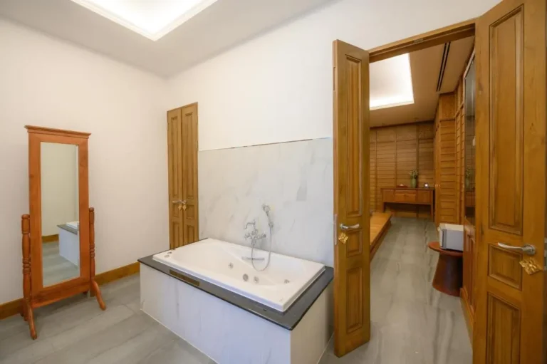 Indoor Spa Area with Built-In Bathtub and Wooden Adjoining Room in Chang Khlan Chiang Mai