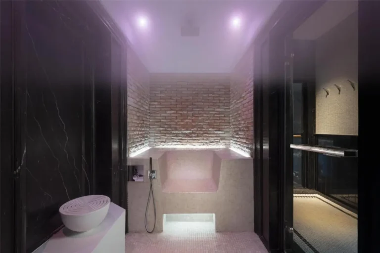 Indoor Steam Room with Mosaic Seating and Ambient Lighting in Pathumwan Wellness Center