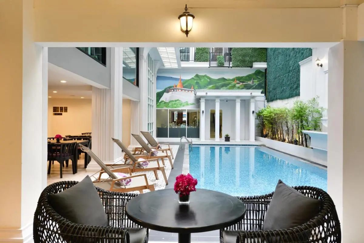 Indoor Swimming Pool and Relaxation Area with Lounge Chairs and Skylight in Phra Nakhon