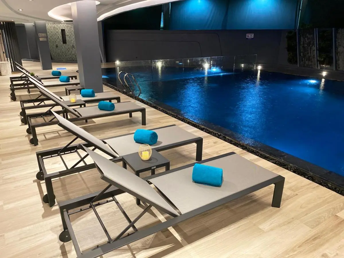 Indoor Swimming Pool Area with Lounge Chairs and Vertical Garden in Phuket Town