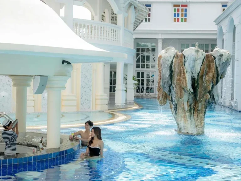 Indoor Swimming Pool with Swim-Up Bar and Waterfall Feature at Patong Beach