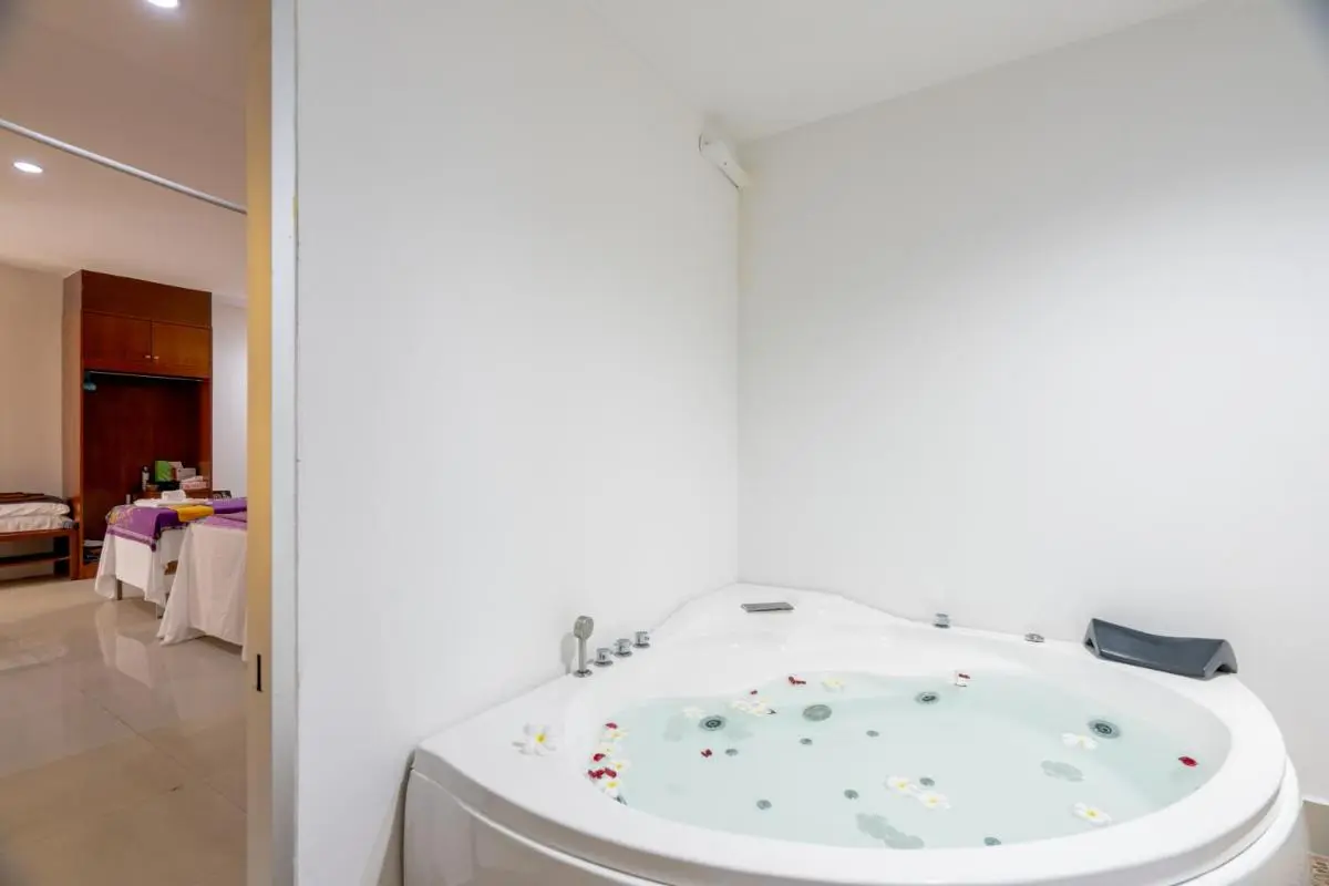 Blue Beach Grand Resort And Spa Indoor Wellness Area Featuring Jacuzzi Tub and Massage Tables Near Rawai Beach Thailand