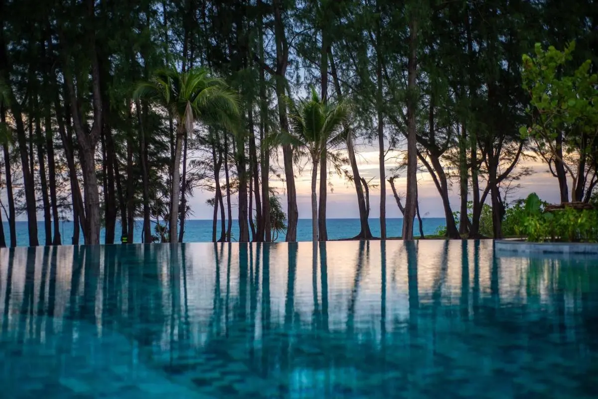 Le Meridien Phuket Mai Khao Beach Resort Infinity Edge Swimming Pool Overlooking Ocean and Lush Tropical Trees at Mai Khao Beach Phuket Province