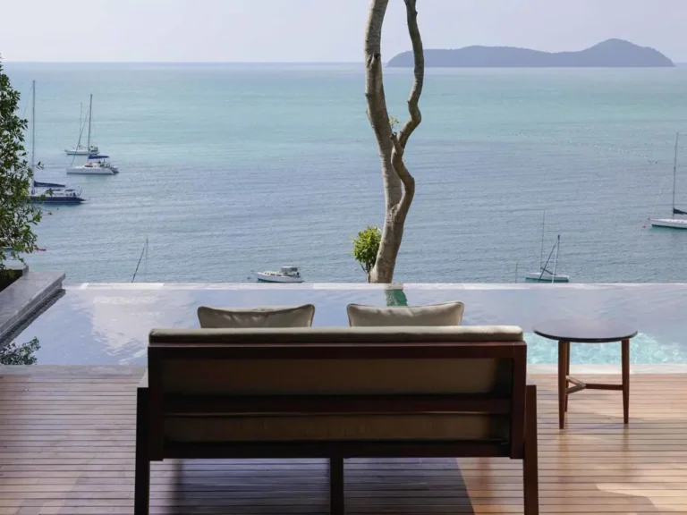 Infinity Pool Overlooking Ocean with Wooden Deck and Secluded Seating at Panwa Beach