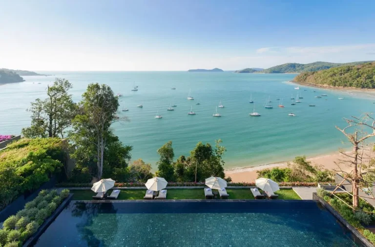 Infinity Pool Overlooking Panwa Beach with Lounge Chairs and Coastal Views