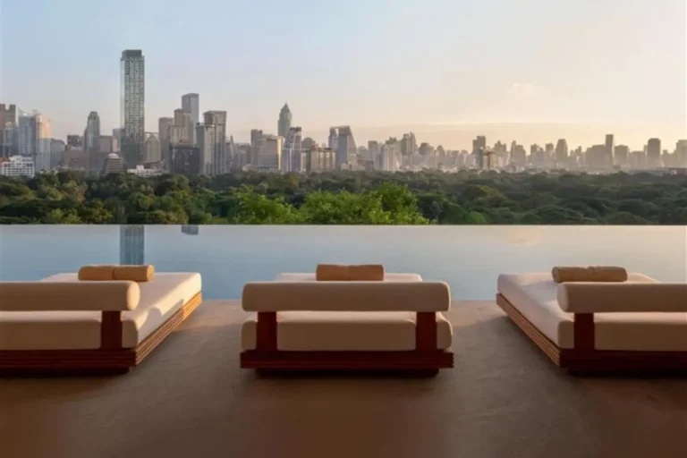 Infinity Pool with Panoramic City Skyline Views and Lounge Chairs in Bang Rak