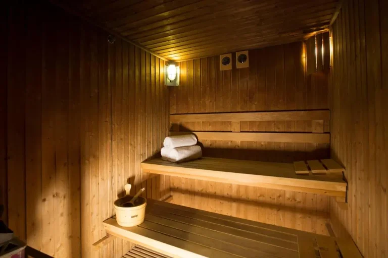 Interior of a Wooden Sauna Room with Benches and Towels in Bang Rak