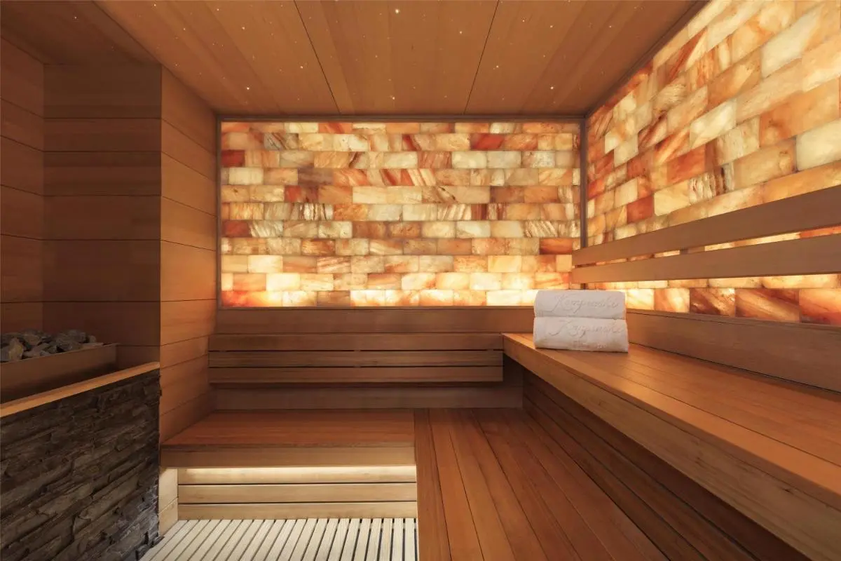 Interior View of a Wooden Sauna Room with Salt Block Lighting in Pathumwan