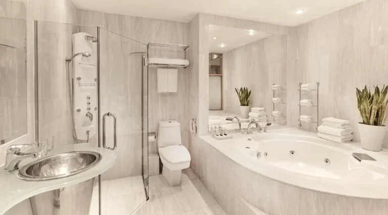 Jacuzzi Tub and Shower Area in Singapore Bathroom with Tiled Platform and Glass Enclosure