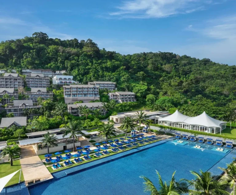 Large Outdoor Swimming Pool with Lounge Chairs and Cabana Seating at Kamala Beach Resort