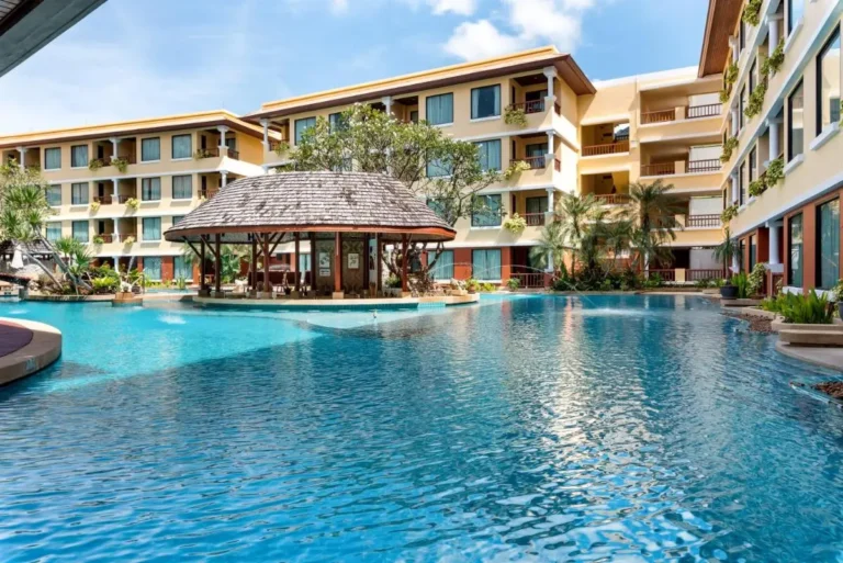 Large Outdoor Swimming Pool with Thatched Roof Structure at Patong Beach Residential Complex