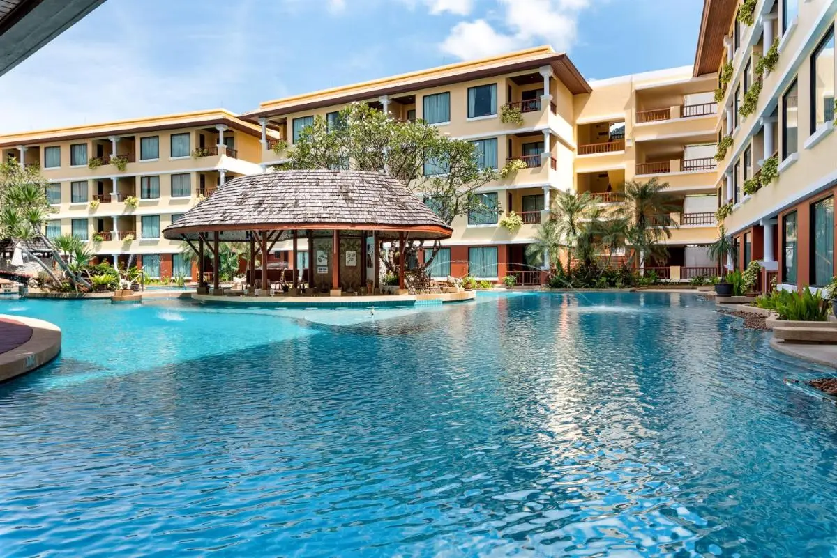 Large Outdoor Swimming Pool with Thatched Roof Structure at Patong Beach Residential Complex