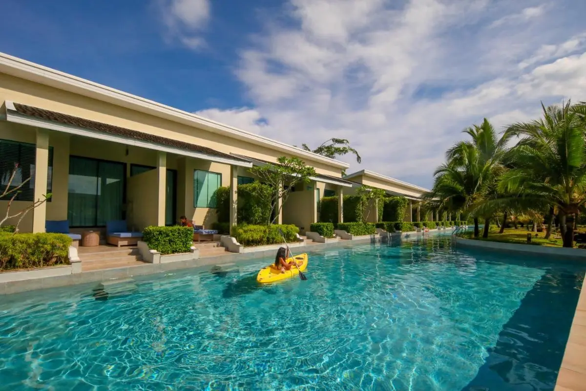 Long Outdoor Swimming Pool with Adjacent Residential Units and Kayak in Phuket Town