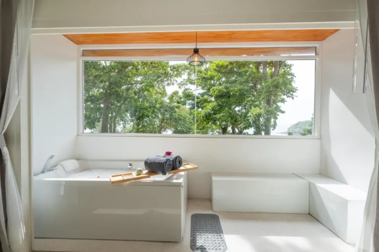 Minimalist Indoor Bathtub Area with Natural Light and Greenery View at Karon Beach