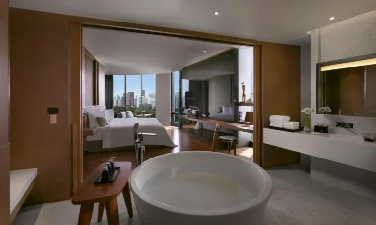 Modern Bang Rak Suite Featuring Freestanding Bathtub and Urban Skyline Views