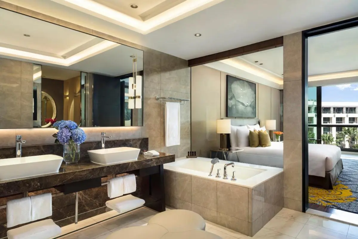 Modern Bathroom and Bedroom Design Featuring Built-In Bathtub and Double Vanity in Pathumwan