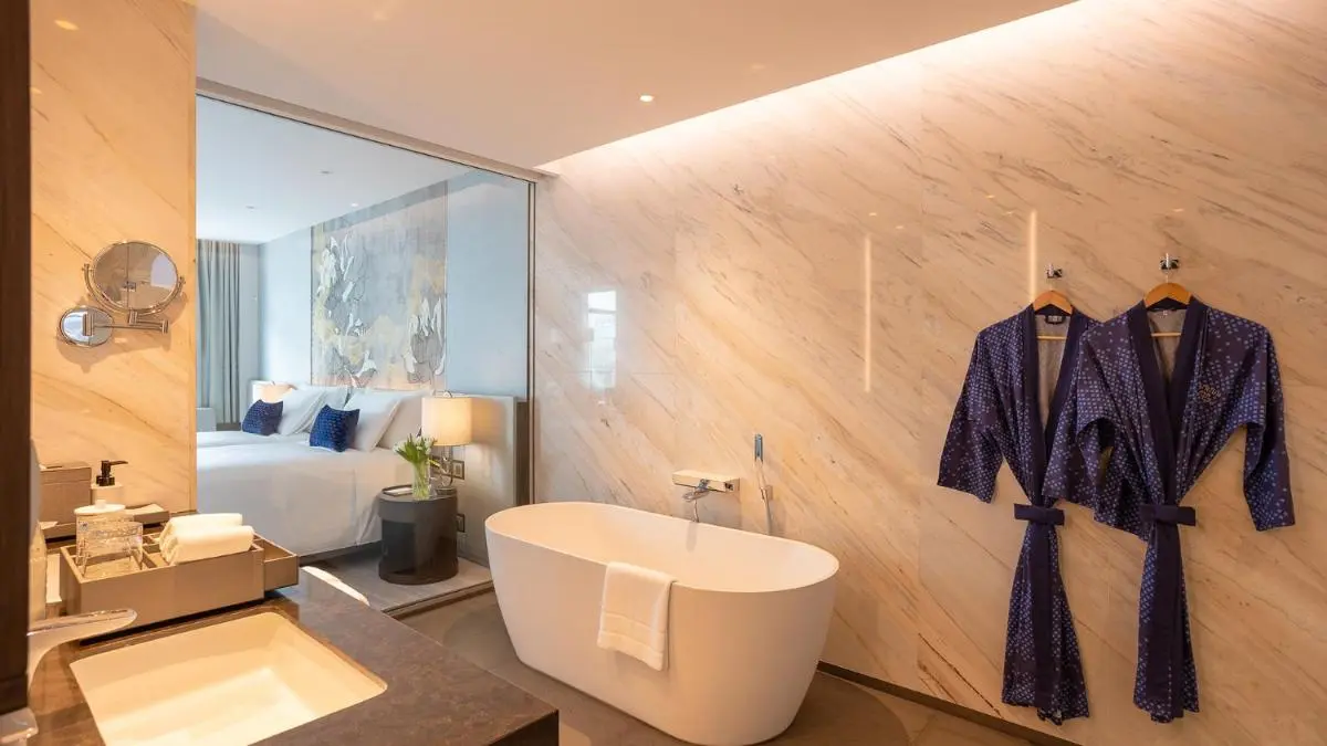 Chatrium Grand Bangkok Modern Bathroom and Bedroom Design with Freestanding Tub and Blue Accents in Ratchathewi