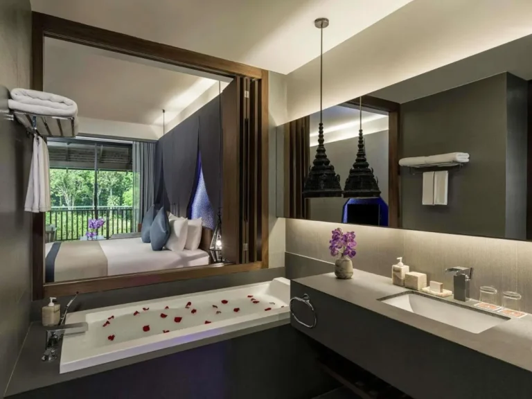 Modern Bathroom and Bedroom with Bathtub Featuring Flower Petals and Natural View at Patong Beach
