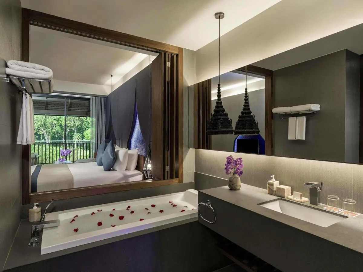 Modern Bathroom and Bedroom with Bathtub Featuring Flower Petals and Natural View at Patong Beach