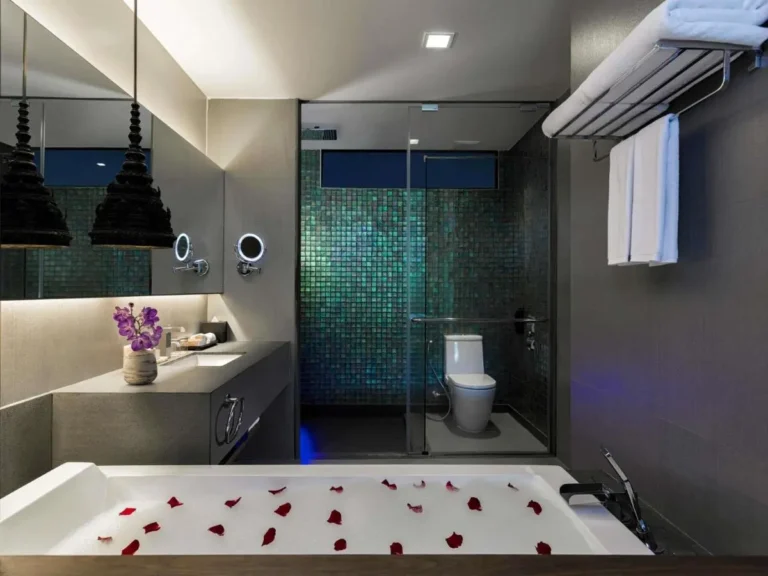 Modern Bathroom Design Featuring Bathtub with Rose Petals and Glass-Enclosed Shower