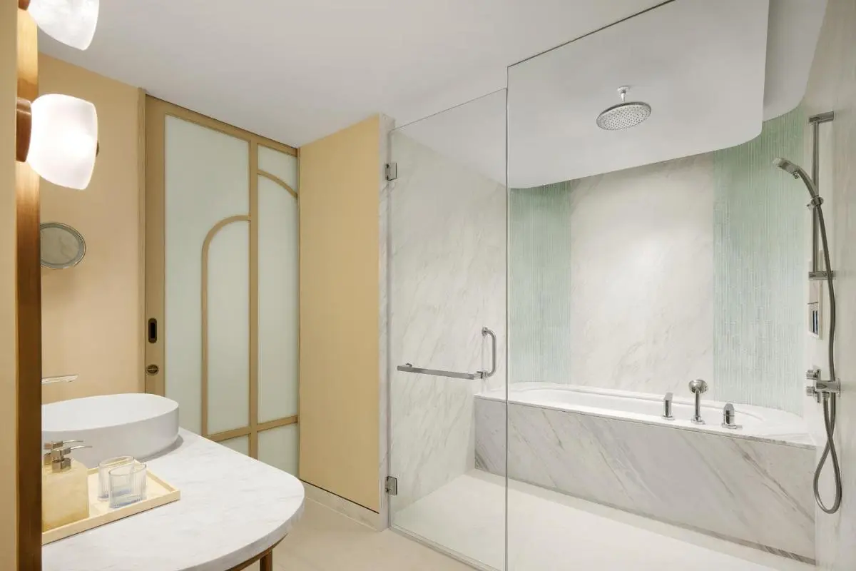Modern Bathroom Design Featuring Combined Shower and Bathtub with Marble and Green Tile Accents