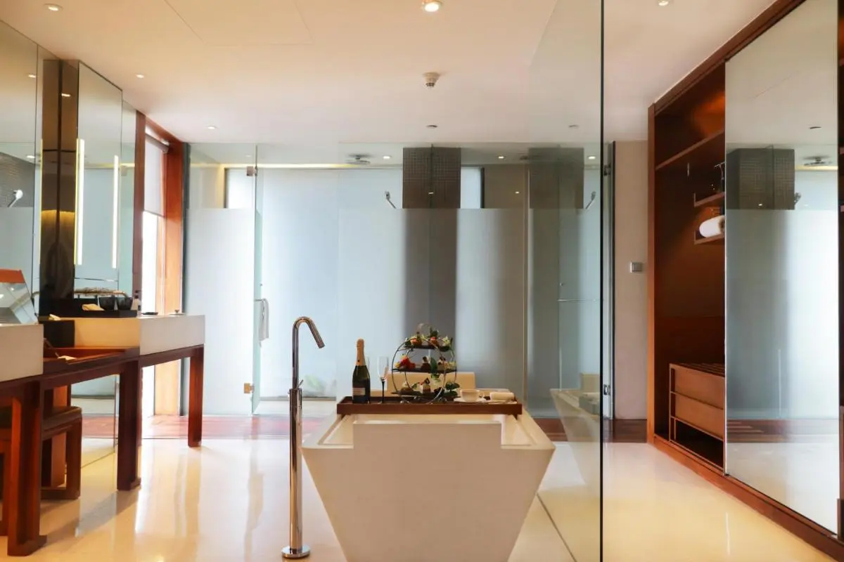 Hansar Bangkok Hotel Modern Bathroom Design with Freestanding Bathtub and Glass Showers in Pathumwan Bangkok