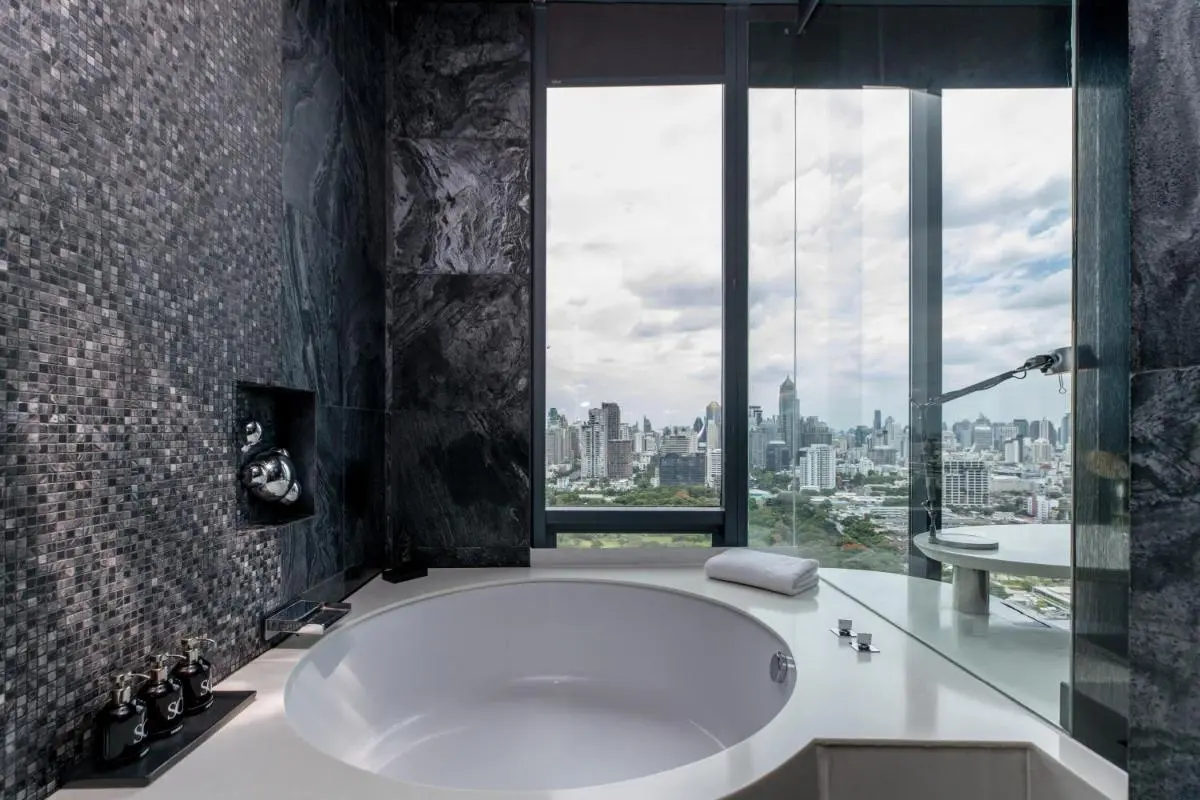 Modern Bathroom with Circular Bathtub and City Skyline View in Bang Rak