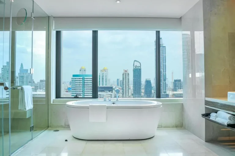 Modern Bathroom with Freestanding Bathtub and City Skyline View in Pathumwan Bangkok