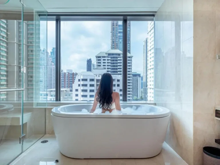 Modern Bathroom with Freestanding Bathtub and Cityscape View in Pathumwan Bangkok