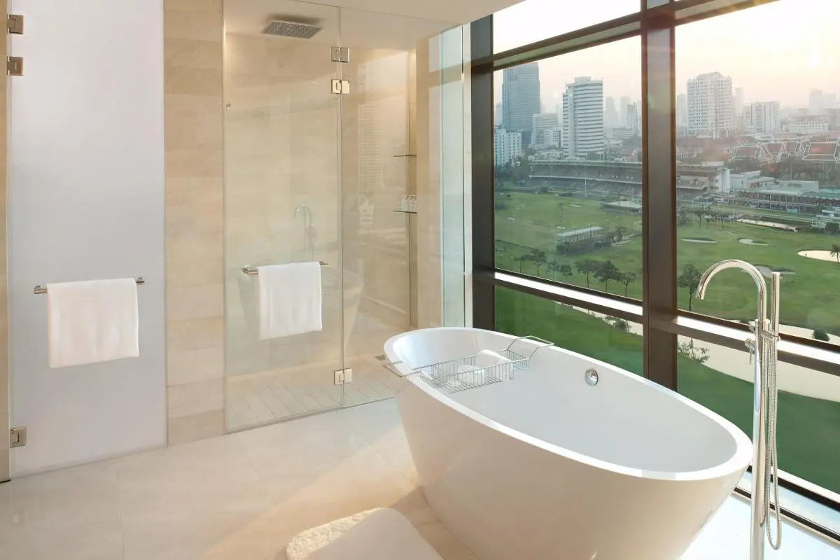Modern Bathroom with Freestanding Tub and Scenic Golf Course View in Pathumwan Bangkok