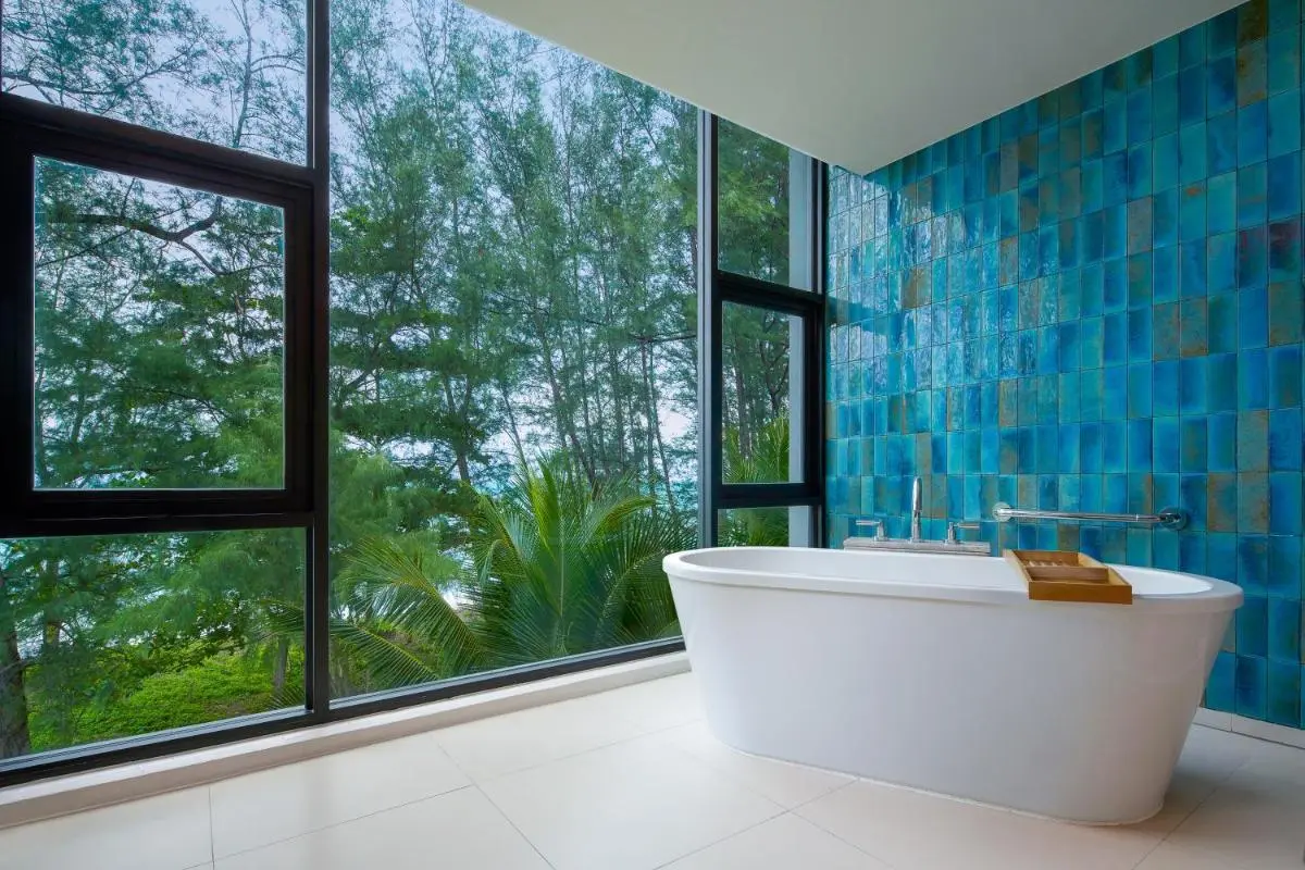 Modern Bathroom with Freestanding Tub and Scenic Views of Mai Khao Beach Foliage
