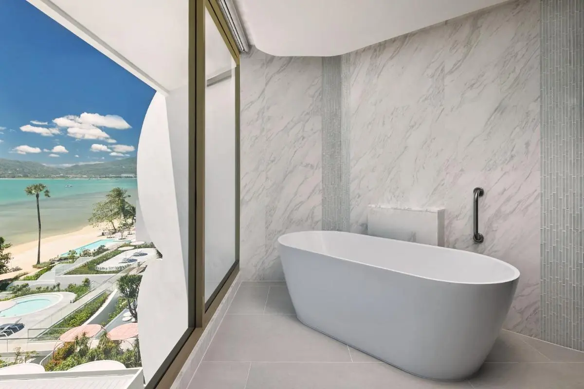 Modern Bathroom with Freestanding Tub Overlooking Pools and Panwa Beach Scenery