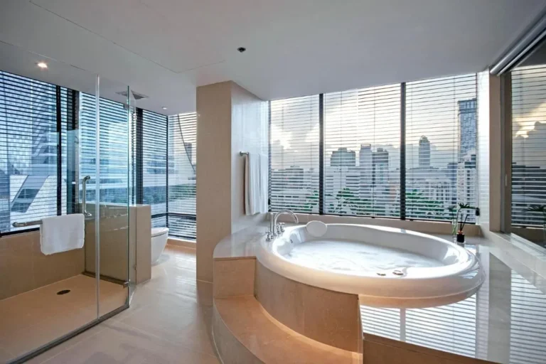 Modern Bathroom with Jacuzzi Tub and City Skyline Views in Pathumwan Bangkok