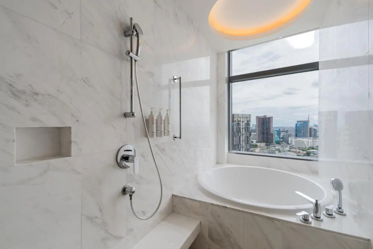 Bangkok Marriott Hotel Sukhumvit Modern Bathroom with Marble Bathtub and Shower Overlooking Wattana Cityscape