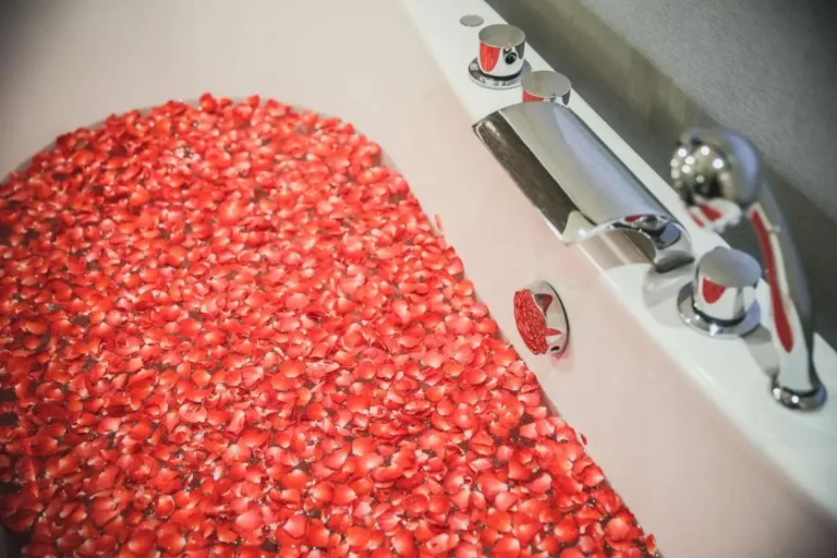 Modern Bathtub with Rose Petals and Chrome Fixtures in Sathorn Bathroom