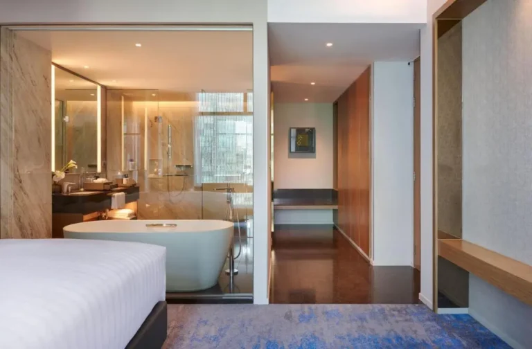Modern Bedroom and Bathroom with Freestanding Tub and Glass Partition in Ratchathewi