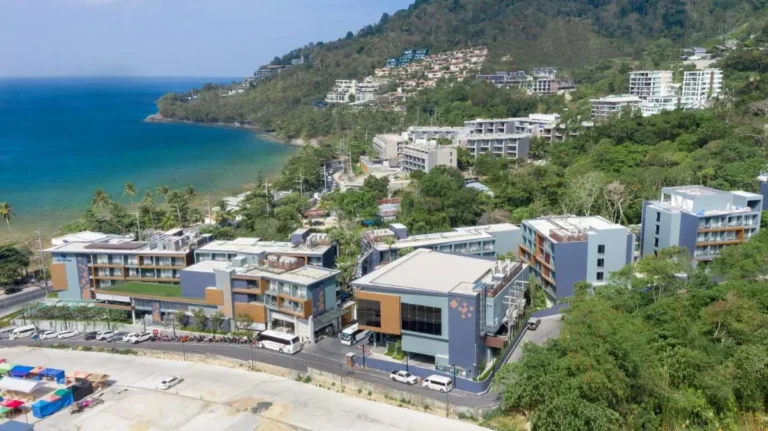 Modern Coastal Buildings and Natural Hillside Landscape Near Patong Beach Shoreline