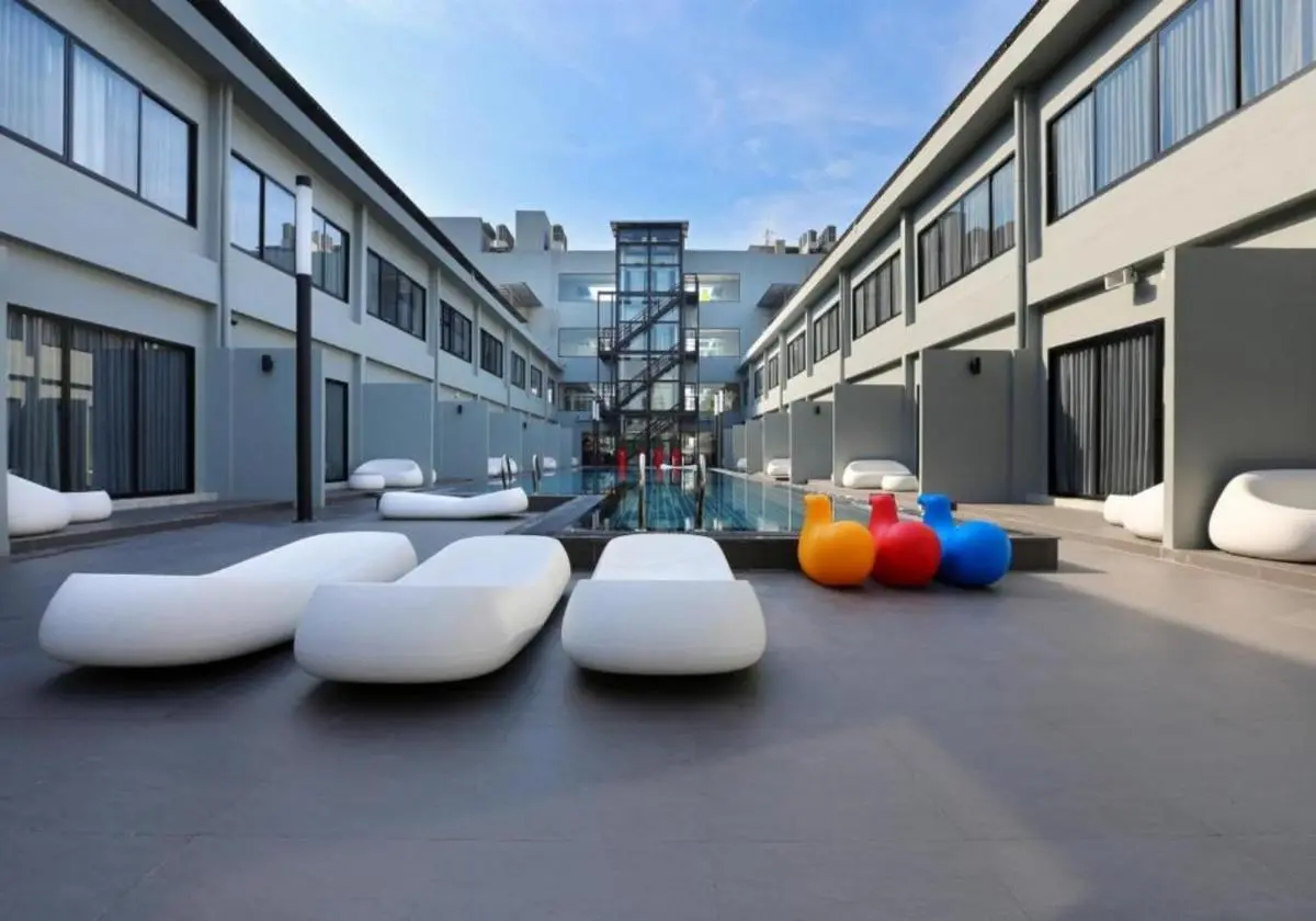 Modern Courtyard Swimming Pool and Seating Area in Huai Khwang Urban Complex