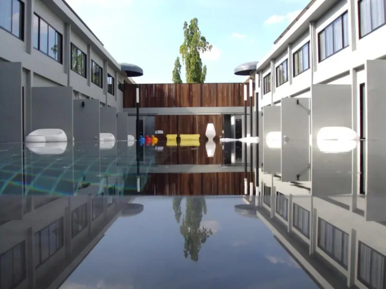 Modern Courtyard with Rectangular Swimming Pool and Colorful Seating in Huai Khwang Bangkok