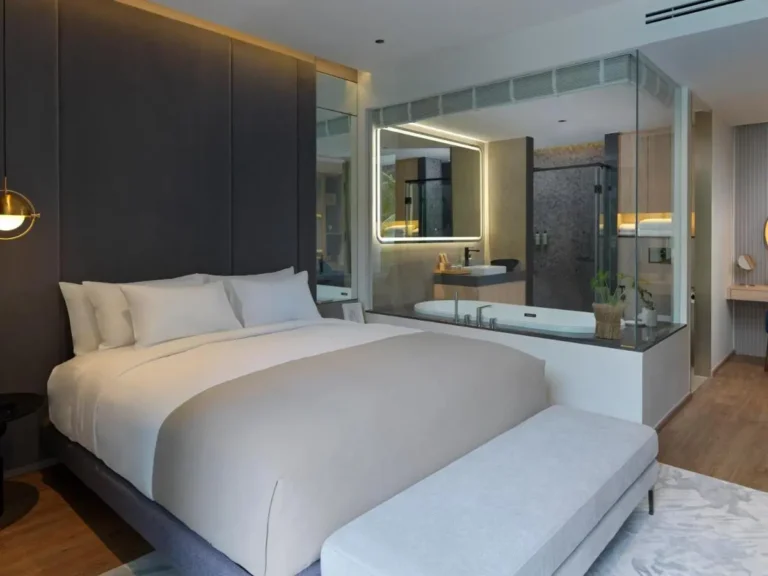 Modern Hotel Room Featuring Glass-Enclosed Bathroom with Bathtub and Shower at Bang Tao Beach