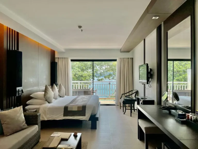 Modern Hotel Room with Balcony Overlooking Greenery and Water at Panwa Beach