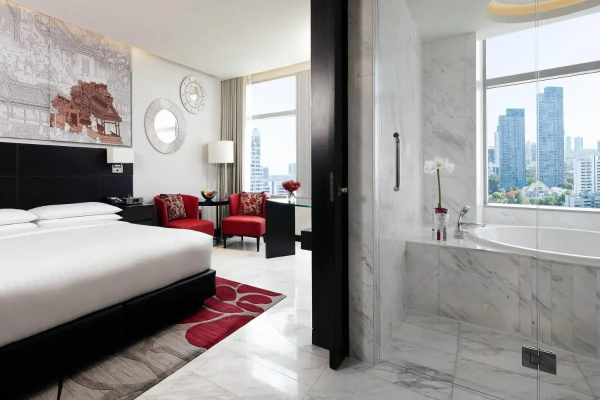 Bangkok Marriott Hotel Sukhumvit Modern Hotel Room with City View Bathtub and Red Accent Chairs in Wattana