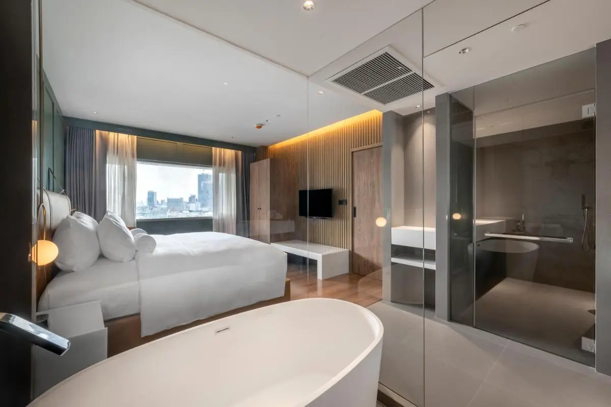 Modern Hotel Room with Freestanding Bathtub and Cityscape View in Khlong Toei Bangkok