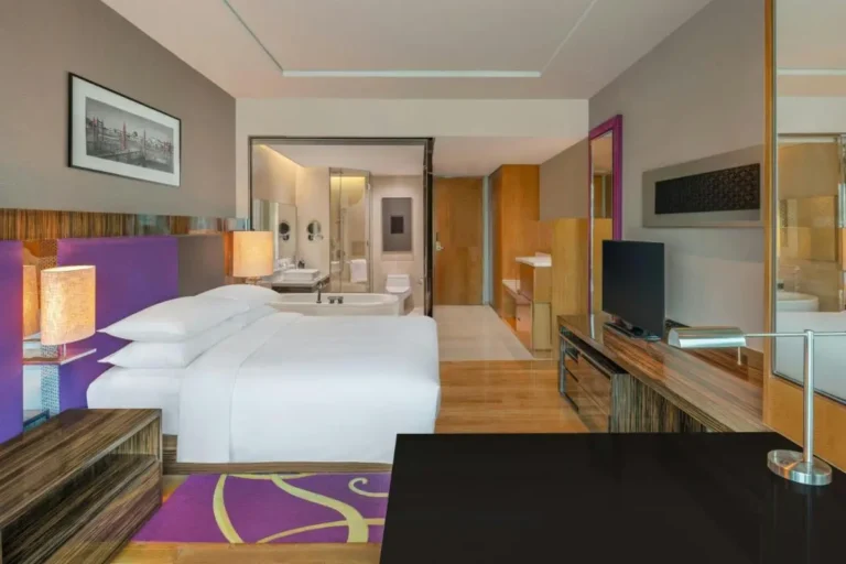 Modern Hotel Room with Glass Bathroom Partition and Purple Accents in Pathumwan Bangkok
