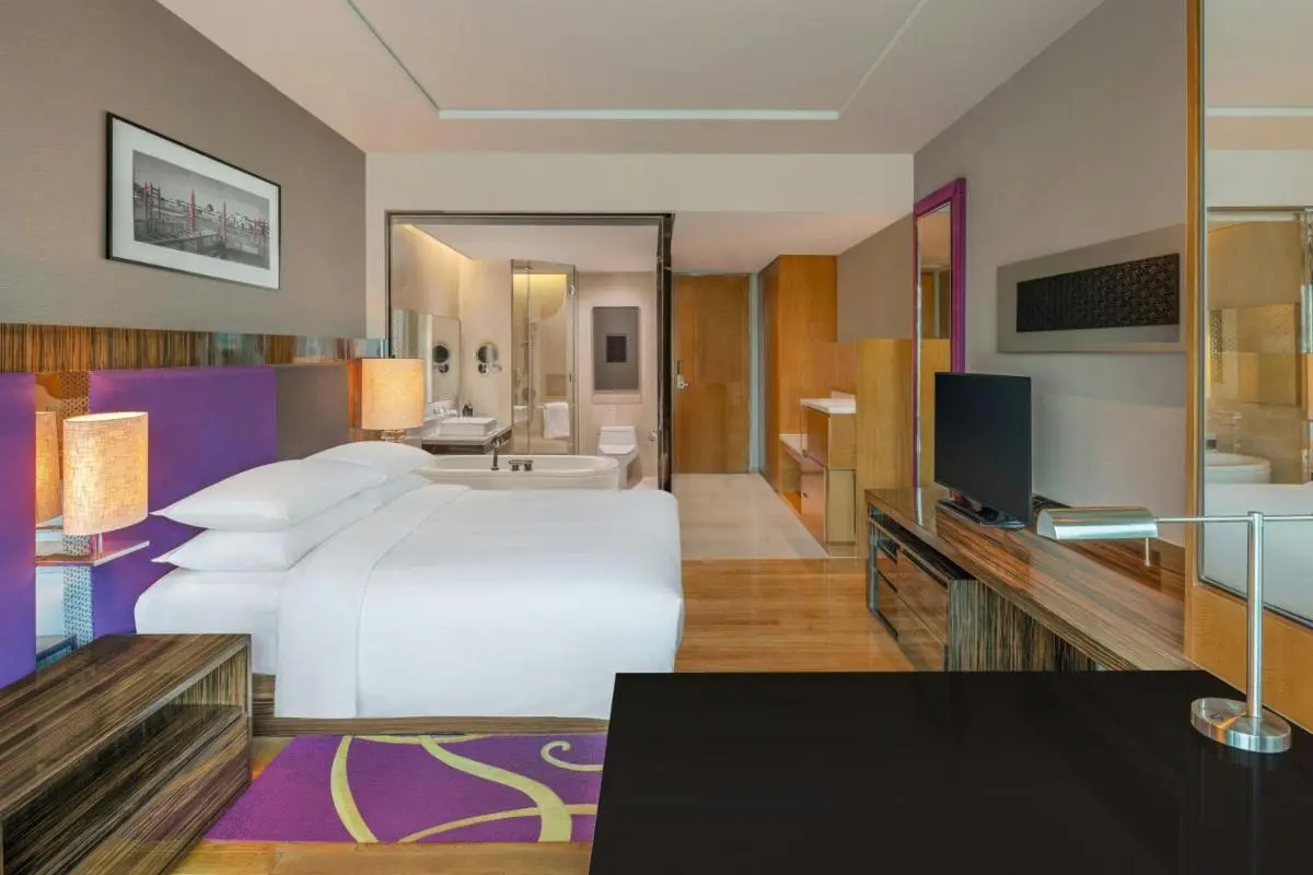 Modern Hotel Room with Glass Bathroom Partition and Purple Accents in Pathumwan Bangkok